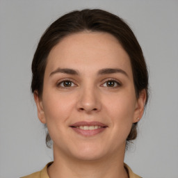 Joyful white young-adult female with medium  brown hair and brown eyes