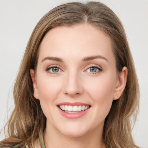 Joyful white young-adult female with medium  brown hair and green eyes