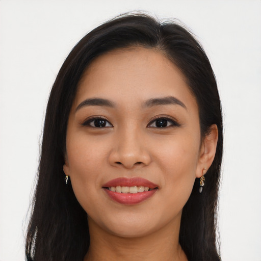 Joyful latino young-adult female with long  brown hair and brown eyes