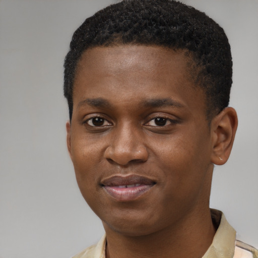 Joyful black young-adult male with short  brown hair and brown eyes