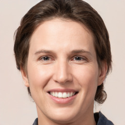 Joyful white young-adult female with medium  brown hair and grey eyes