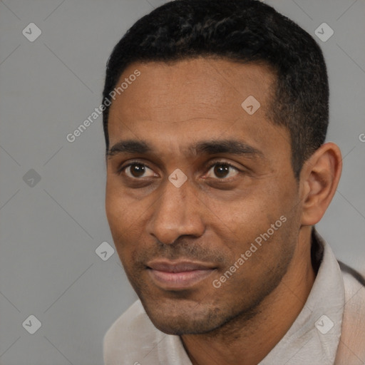 Joyful black young-adult male with short  black hair and brown eyes