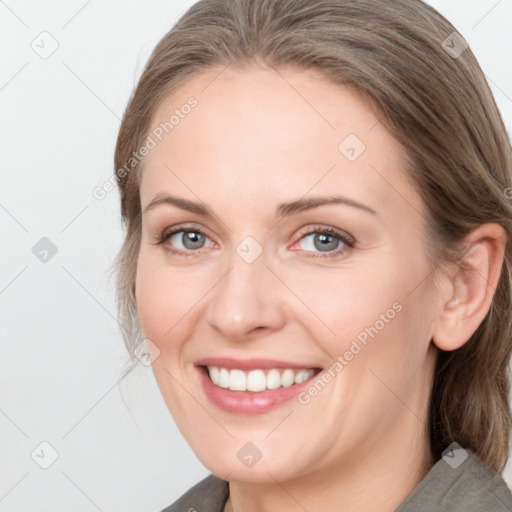 Joyful white young-adult female with medium  brown hair and grey eyes