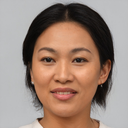 Joyful asian young-adult female with medium  black hair and brown eyes