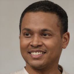 Joyful latino young-adult male with short  brown hair and brown eyes