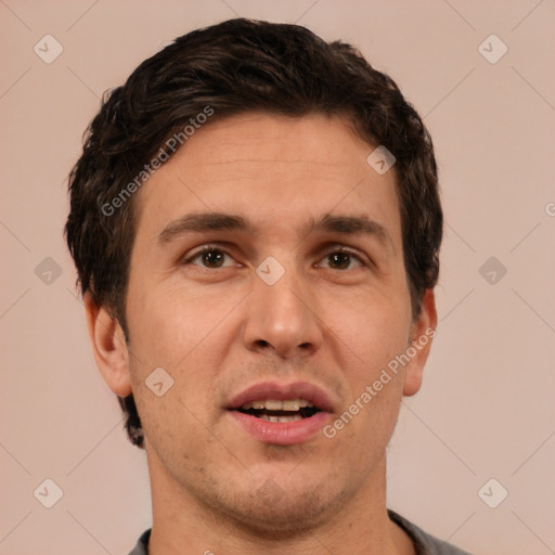 Joyful white adult male with short  brown hair and brown eyes