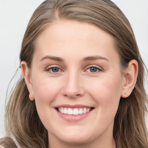 Joyful white young-adult female with long  brown hair and grey eyes