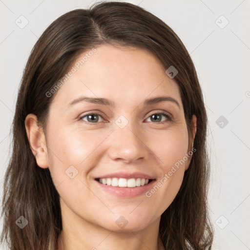 Joyful white young-adult female with long  brown hair and brown eyes