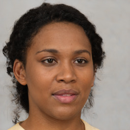 Joyful black adult female with short  brown hair and brown eyes