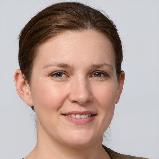 Joyful white young-adult female with short  brown hair and grey eyes