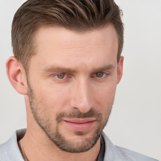 Joyful white young-adult male with short  brown hair and grey eyes