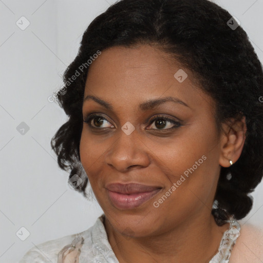 Joyful black adult female with medium  brown hair and brown eyes