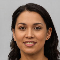 Joyful latino young-adult female with long  brown hair and brown eyes