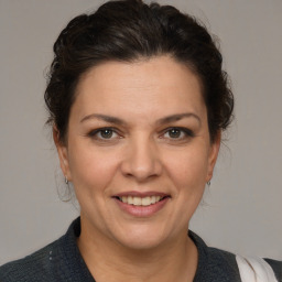 Joyful white adult female with medium  brown hair and brown eyes