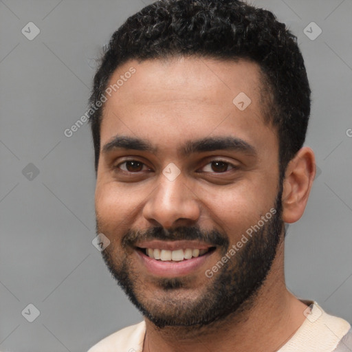 Joyful white young-adult male with short  black hair and brown eyes