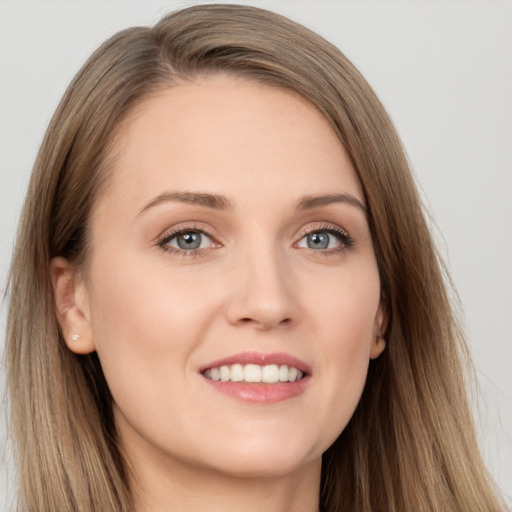 Joyful white young-adult female with long  brown hair and grey eyes