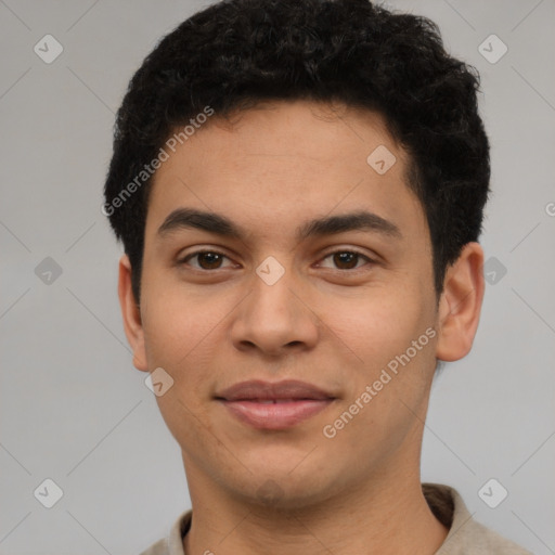 Joyful latino young-adult male with short  brown hair and brown eyes