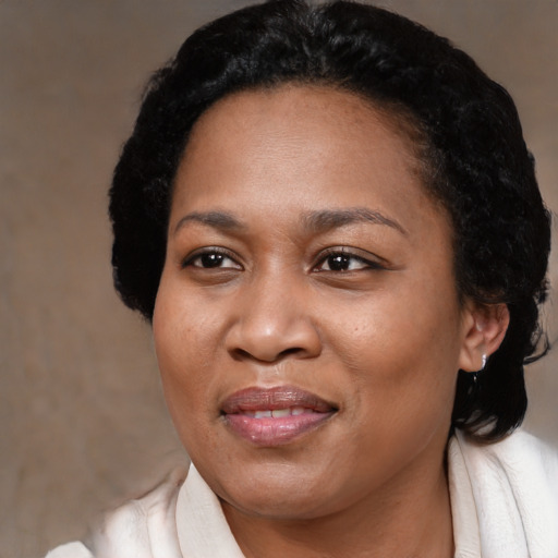Joyful black adult female with medium  black hair and brown eyes