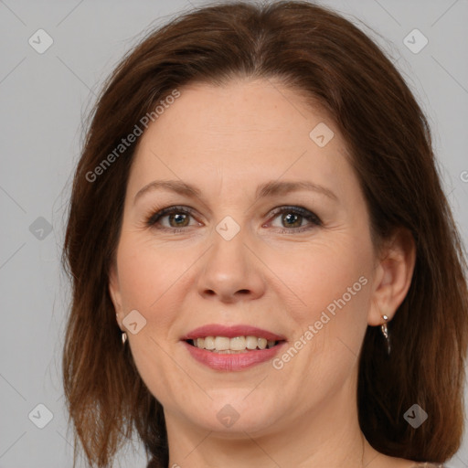 Joyful white adult female with medium  brown hair and grey eyes