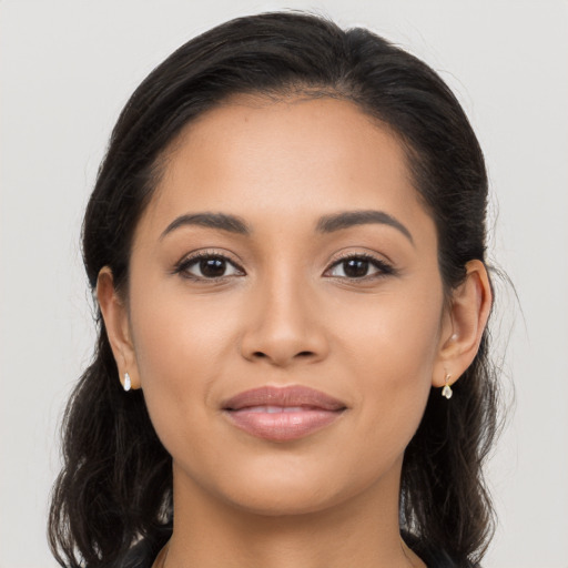 Joyful latino young-adult female with long  brown hair and brown eyes