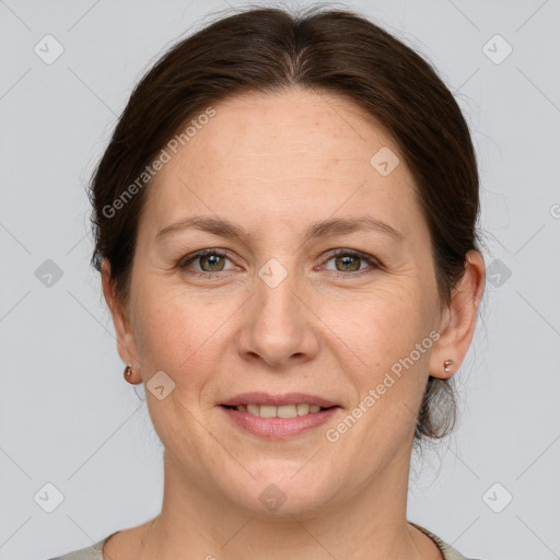 Joyful white adult female with medium  brown hair and grey eyes