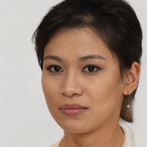 Joyful asian young-adult female with medium  brown hair and brown eyes