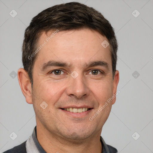 Joyful white adult male with short  brown hair and brown eyes