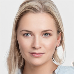 Joyful white young-adult female with long  brown hair and blue eyes