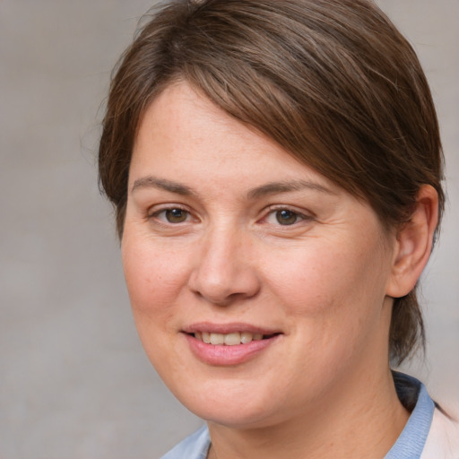 Joyful white adult female with medium  brown hair and brown eyes