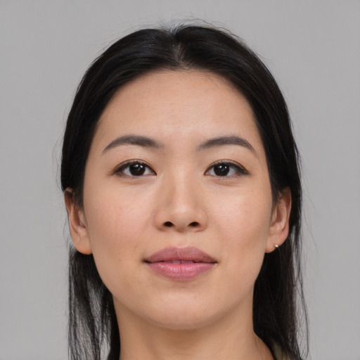 Joyful asian young-adult female with long  black hair and brown eyes