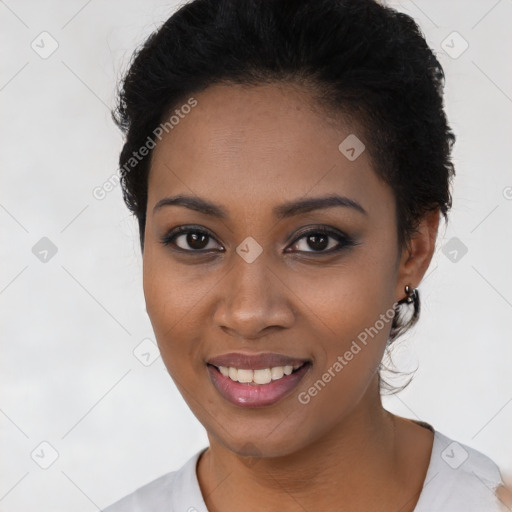 Joyful black young-adult female with short  black hair and brown eyes