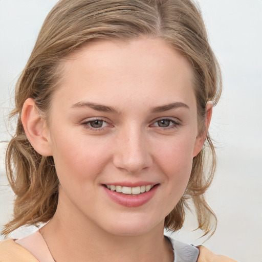 Joyful white young-adult female with medium  brown hair and blue eyes