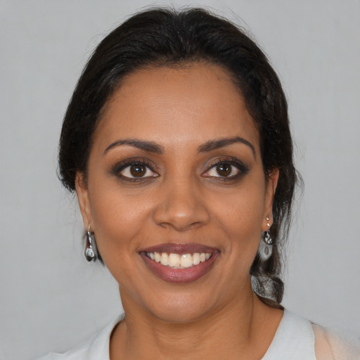 Joyful black young-adult female with medium  brown hair and brown eyes