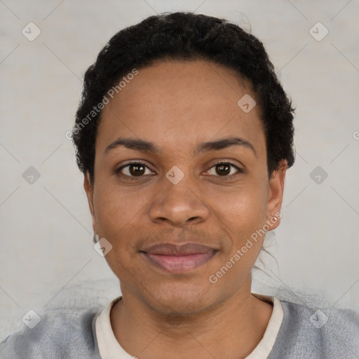 Joyful black young-adult female with short  black hair and brown eyes