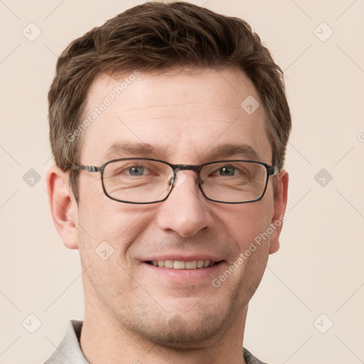 Joyful white adult male with short  brown hair and grey eyes