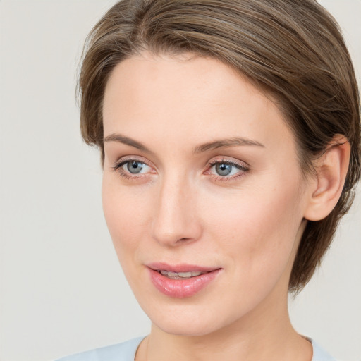 Joyful white young-adult female with medium  brown hair and green eyes