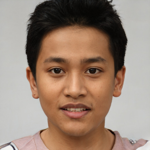 Joyful latino young-adult male with short  black hair and brown eyes