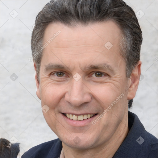 Joyful white adult male with short  brown hair and brown eyes