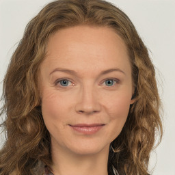 Joyful white young-adult female with long  brown hair and green eyes