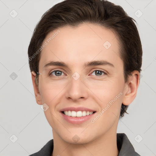 Joyful white young-adult female with short  brown hair and grey eyes