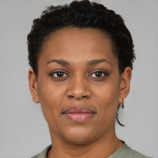Joyful black young-adult female with short  brown hair and brown eyes