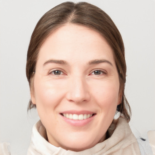 Joyful white young-adult female with medium  brown hair and grey eyes