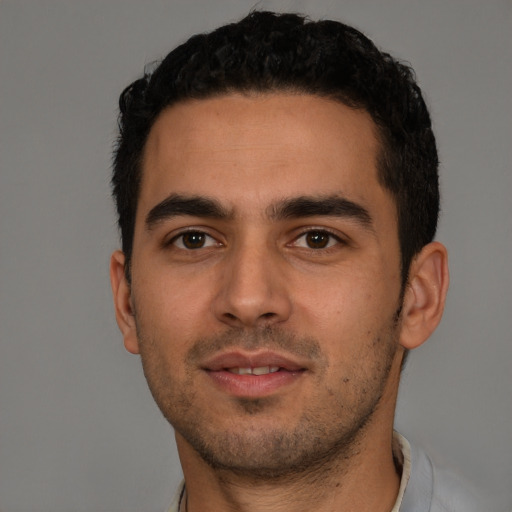 Neutral latino young-adult male with short  black hair and brown eyes