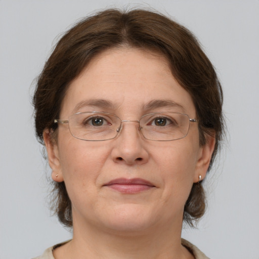 Joyful white adult female with medium  brown hair and grey eyes