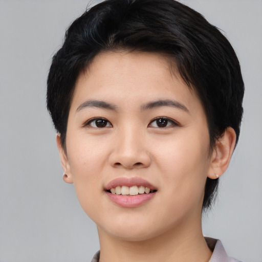 Joyful asian young-adult female with medium  black hair and brown eyes