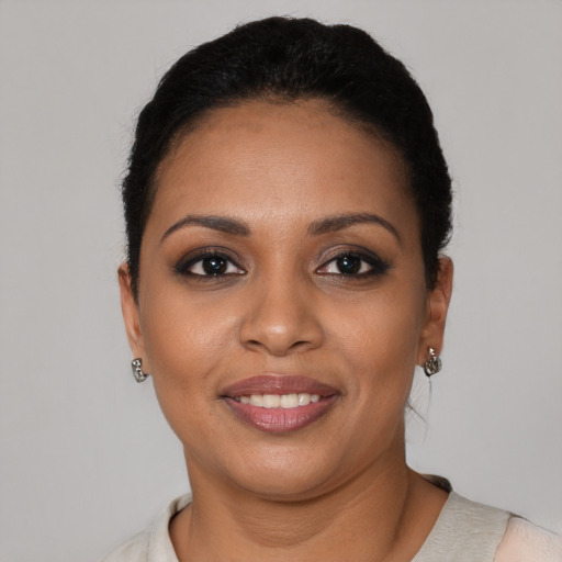 Joyful black young-adult female with short  black hair and brown eyes