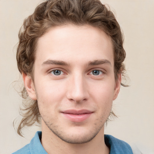 Joyful white young-adult male with short  brown hair and blue eyes