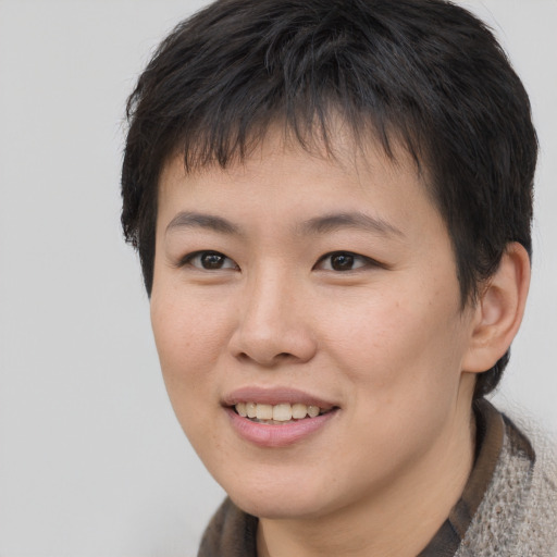 Joyful asian young-adult female with short  brown hair and brown eyes