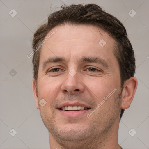 Joyful white adult male with short  brown hair and grey eyes