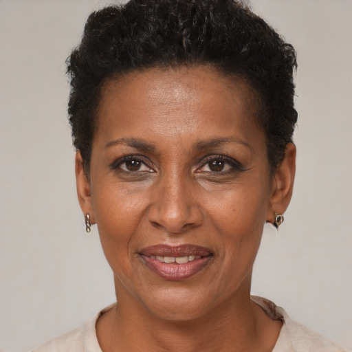 Joyful black adult female with short  black hair and brown eyes